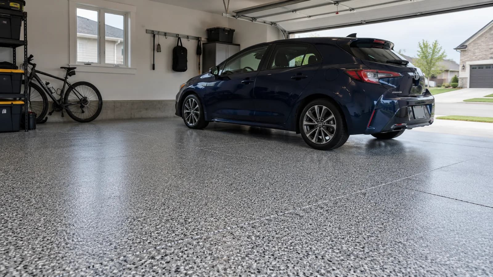 Illustrative two-car garage with a full flake floor coating and a parked car.